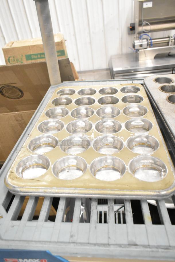 38-item set includes muffin pans and bowls, featuring varied sizes, some wear visible. Ideal for bulk kitchen use.