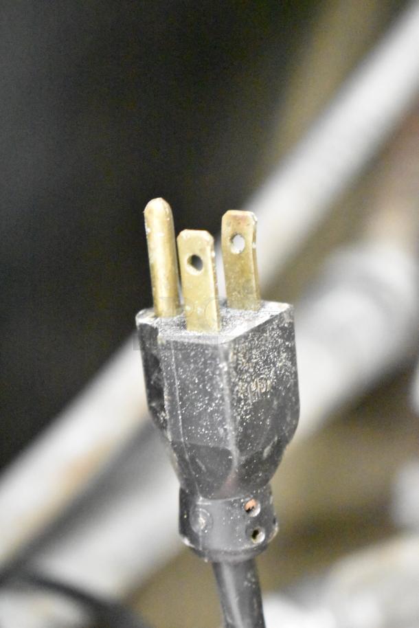 Close-up of a plug for a Cleveland KEL-100 commercial 100-gallon electric kettle, showing three metal prongs.