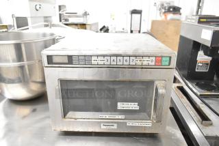 Panasonic NE-21521 commercial microwave oven, stainless steel, visible buttons, used condition, 208 volts, countertop model.