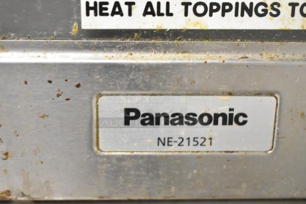 Panasonic NE-21521 Commercial Microwave with label, stainless steel front, visible wear, 208V, 1 Phase.