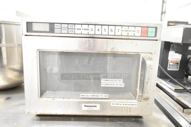 Panasonic NE-21521 commercial microwave oven, 208V, 1 phase, with visible wear. Control panel and warning labels shown.