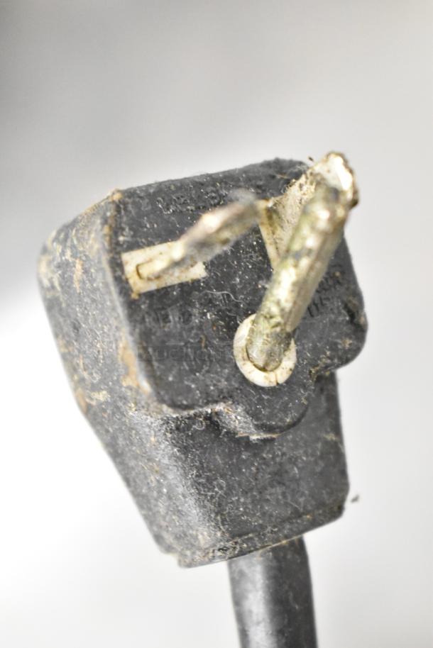 Close-up of a worn power plug from a Panasonic NE-21521 Commercial Countertop Microwave Oven.