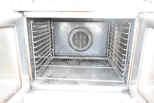 Blodgett Mark V commercial convection oven with view-through doors, thermostatic controls, and caster legs. Inner racks visible.