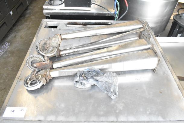 Blodgett Mark V convection oven legs with casters on a table, showing some rust and wear, auction tag visible.