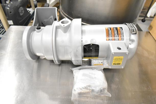 Hoabrt Garbage Disposal, 115/230/110/220 Volts, 1 Phase, in new condition. Includes warning labels and voltage specifications.