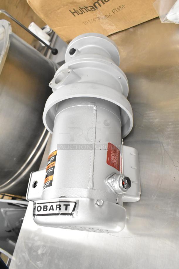 Hobart garbage disposal, silver, multi-voltage (115/230/110/220V), 1 phase, excellent condition, with warning labels visible.
