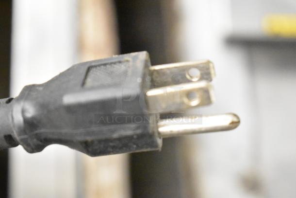Close-up of a power plug for the Avantco 178UBB3GHC Commercial Back Bar Cooler, showing standard prongs for 115 volts.