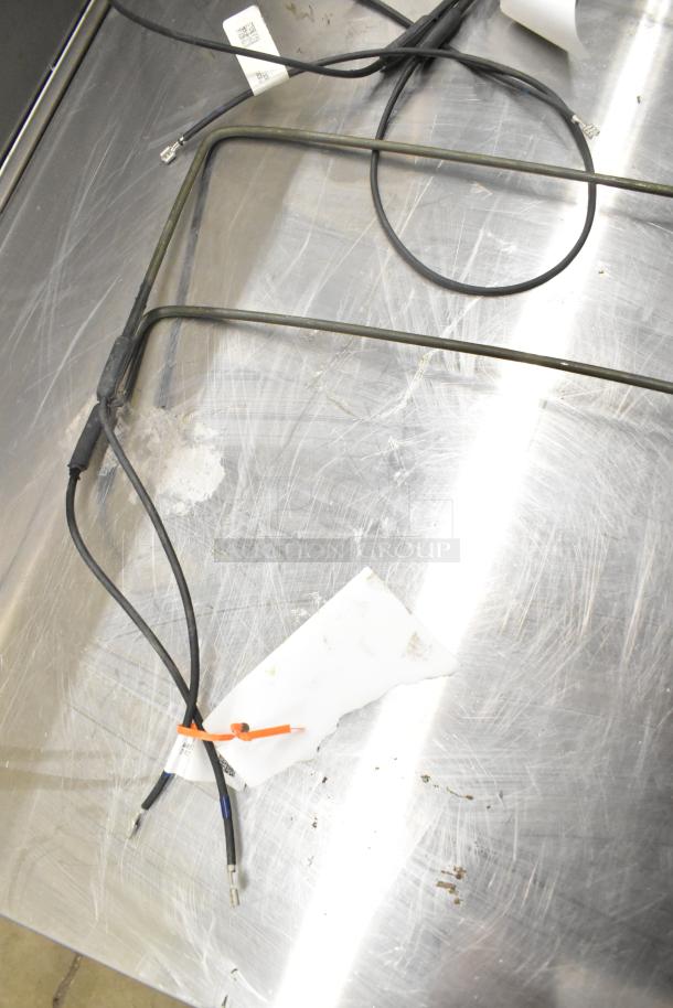 3 Heatcraft items: 3974403S Pan Heater, 39724752203 Drain Pan Heater, 39724710202 Defrost Coil Element. Wires and tags visible.