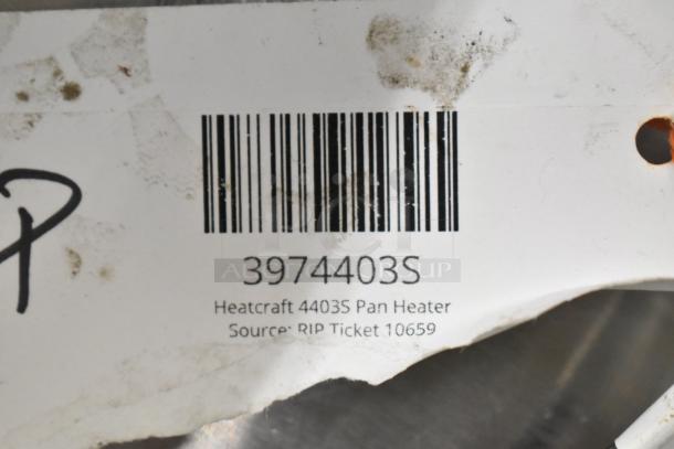 Heatcraft 4403S pan heater label with barcode, model 3974403S, and source info, ticket 10659, slightly worn condition.