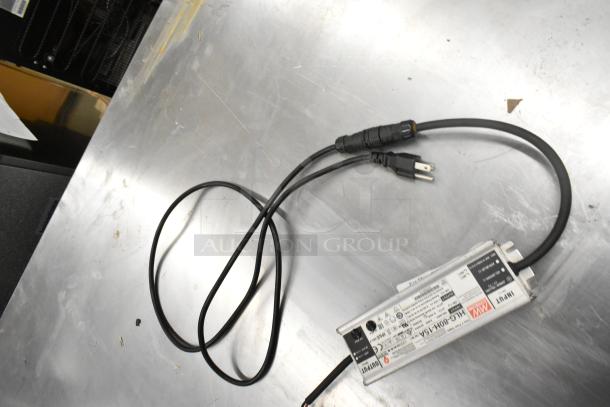 Mean Well MW HLG-80H-15A power supply, metallic casing, attached cables, visible labeling, in good condition.
