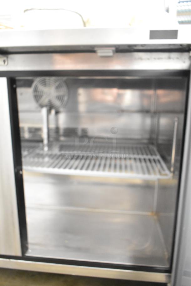 Turbo Air MUR-48-N undercounter cooler, stainless steel, 2-door, on casters. 115V, used, clean interior, visible shelving.