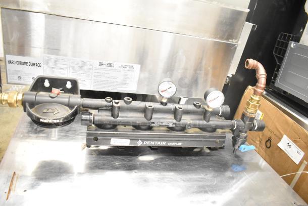 Pentair Everpure water filtration system, used condition, features pressure gauges and labeled components.