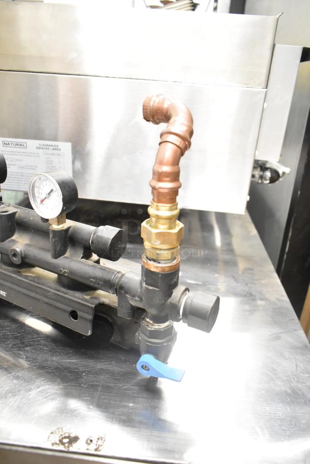 Pentair Everpure water filtration system with pressure gauge and copper fittings, in good condition on a stainless steel surface.