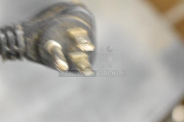 Blurry image of an electrical plug, unrelated to the Turbo Air TUR-72SD-D6-N undercounter cooler description.