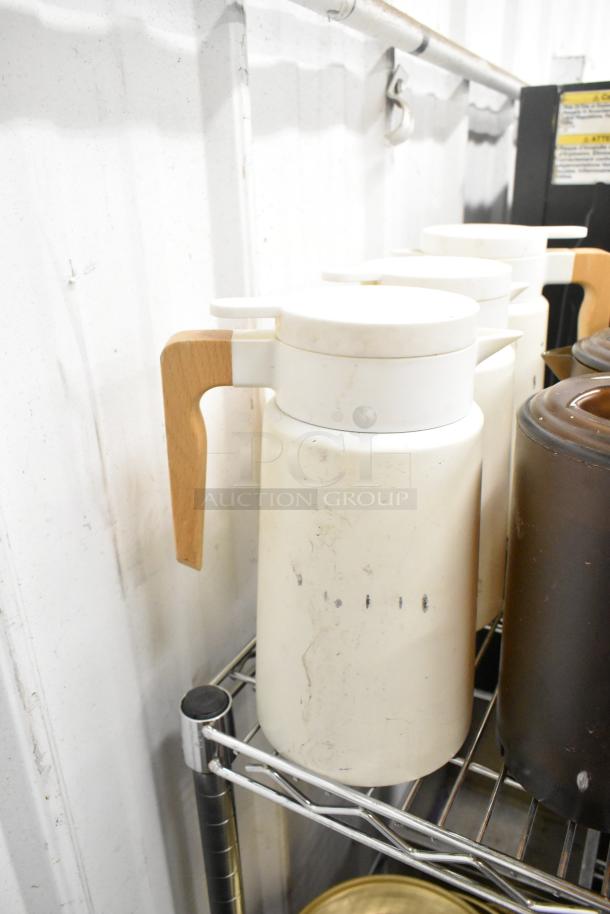 Metro lot items on metal shelf: white poly pitchers with wooden handles, drop-in bins, and rice cooker inserts. Good condition.