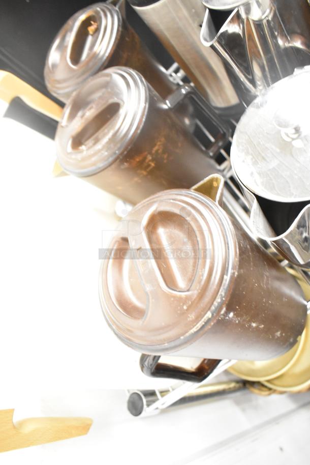 Auction lot of kitchen items: brown drop-in bins, silver poly pitchers, and cutting boards. Excludes shelving unit.