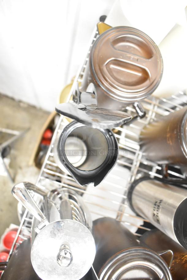 Metro lot of assorted kitchen items including drop-in bins, poly pitchers, cutting boards, and rice cooker inserts.