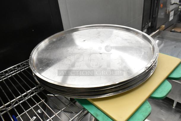 Stack of metal lids on cutting boards, part of a Metro lot including bins, pitchers, and rice cooker inserts. Shelving not included.