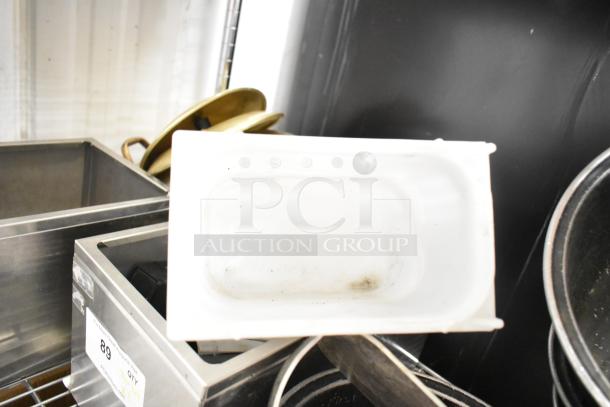 Metro lot with drop-in bins, poly pitchers, cutting boards, rice cooker inserts. Shelving unit not included. Mixed condition.