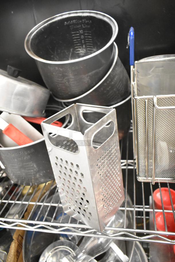 Metro lot with various kitchen items, including drop-in bins, poly pitchers, cutting boards, and rice cooker inserts.