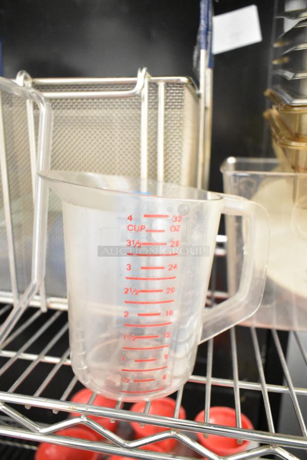 Metro lot with a clear poly pitcher with red measurements, metal drop-in bins, cutting boards, and rice cooker inserts.