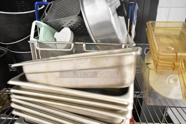 Auction lot with drop-in bins, poly pitchers, cutting boards, rice cooker inserts, and utensils. No shelving unit.