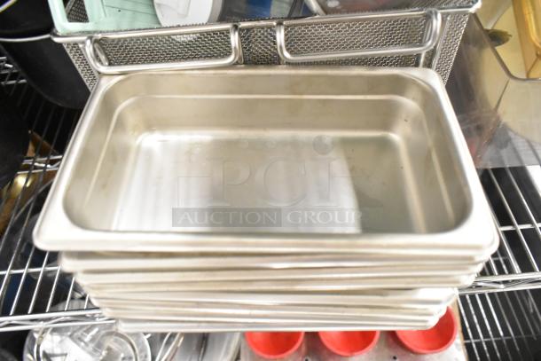 Metro lot including stack of stainless steel drop-in bins on shelving, poly pitchers, cutting boards, and utensils.