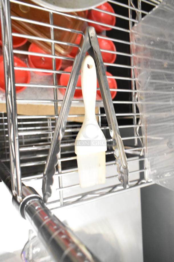Assorted kitchen items on metal rack; includes tongs, paintbrush, and plastic containers. Excludes shelving unit.