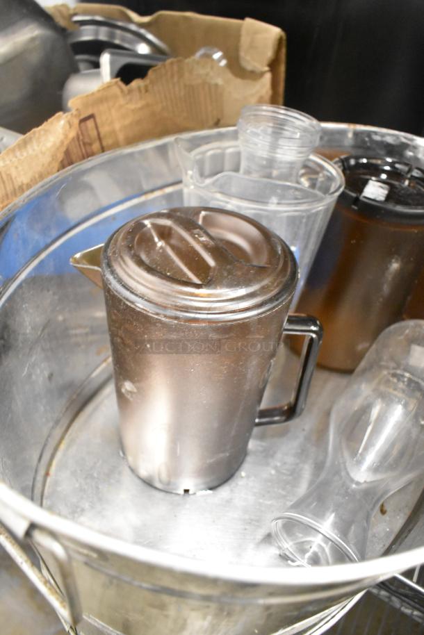 Metro lot with drop-in bins, poly pitchers, cutting boards, rice cooker inserts, utensils; visible wear, no shelving included.