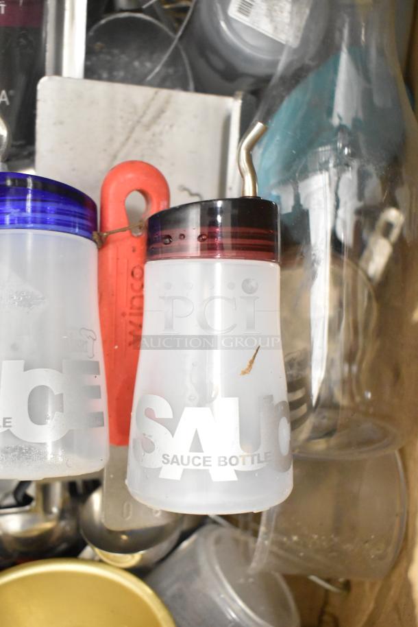 Metro Lot of assorted kitchen items, featuring drop-in bins, Winco utensils, poly pitchers, and sauce bottles.