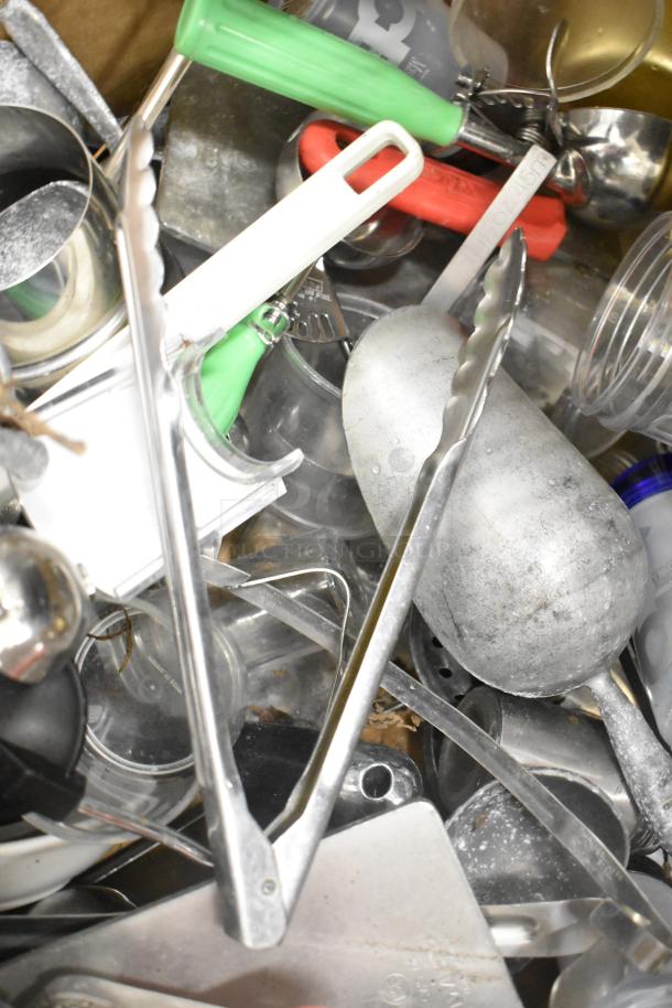 Metro lot of kitchen items including tongs, poly pitchers, cutting boards, and rice cooker inserts. Excludes shelving unit.