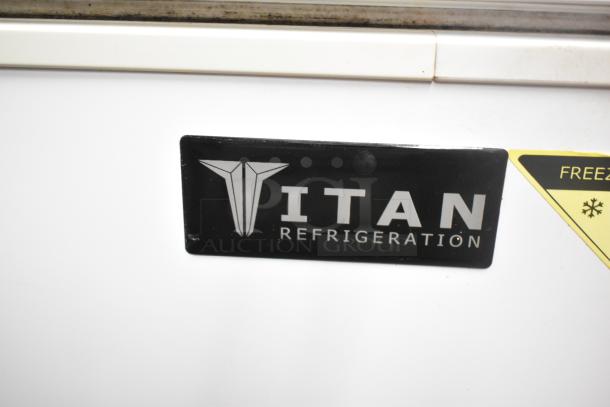 Titan XTCF20 chest freezer with hinge lid, 115V, 1 phase. Features Titan Refrigeration logo and freezer warning label.