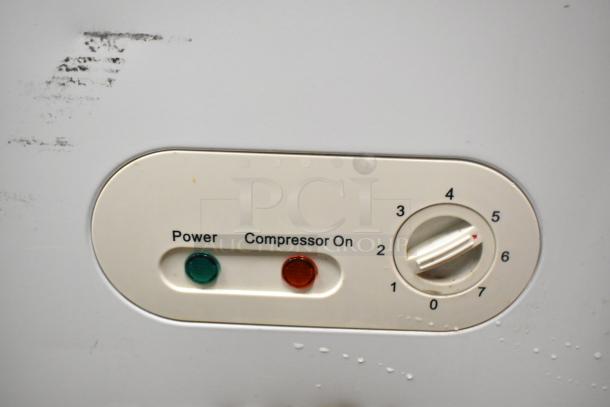 Titan XTCF20 Chest Freezer thermostat panel, featuring power and compressor indicators, dial shows settings 0 to 7.