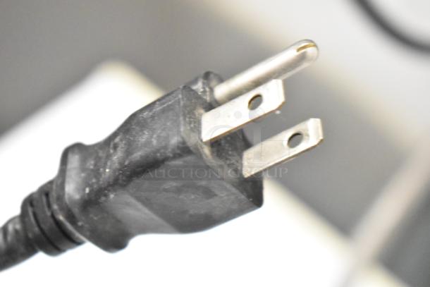 Close-up of a standard three-prong power plug for Manitowoc ID0322A-161 ice machine, 115 volts, 1 phase.