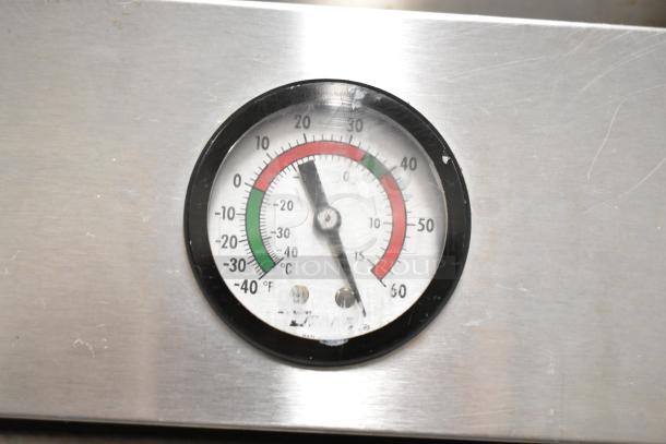 True T-49 Commercial Cooler thermometer, showing temperature range, on stainless steel exterior.
