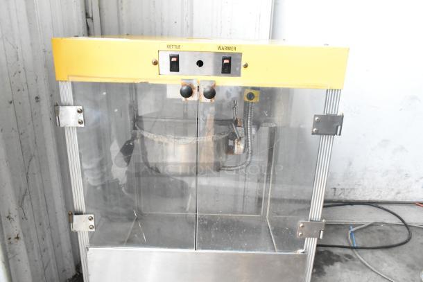 Star 49 countertop popcorn machine, yellow finish, 115 volts, 1 phase, glass doors, stainless steel kettle, used condition.