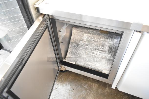 Kutano KUT24DPT commercial sandwich prep table, brand new, visible interior, on casters, 115 volts, 1 phase.