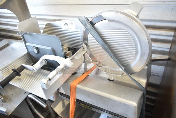 Bizerba VS 12 F commercial manual vertical slicer with blade and handle on metal stand, secured with straps. Model visible.