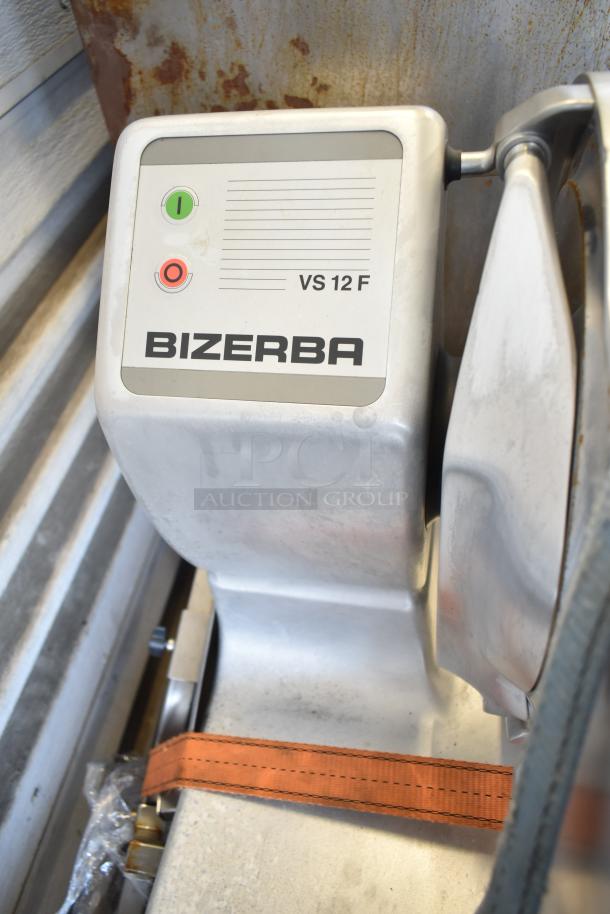 Bizerba VS 12 F commercial manual slicer on stand, gray metal, with control buttons. Good condition, minor wear.