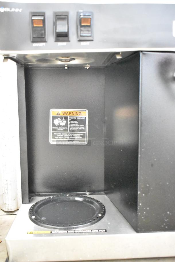 Bunn Commercial 2 Burner Coffee Machine with Hot Water Dispenser, 120V, 1 Phase, features on/off and start buttons, warning label visible.