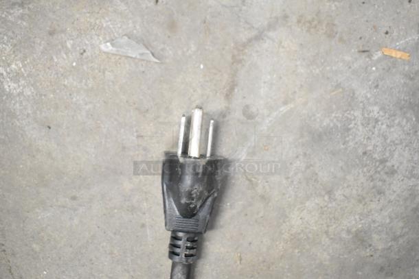 Power plug for Bunn Commercial Countertop Coffee Machine, 120 Volts, shown on concrete surface.
