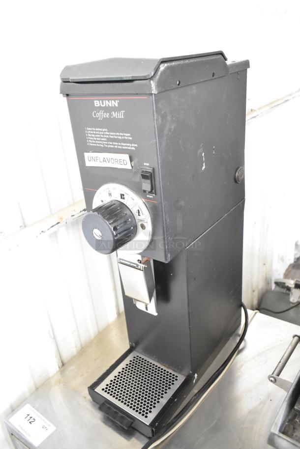 Bunn Commercial Coffee Bean Grinder, black, 120V, 1 phase, visible dial, "Unflavored" label, used condition.