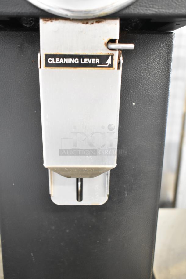 Bunn Commercial Coffee Bean Grinder, countertop model, 120 volts, 1 phase. Features a cleaning lever. Good condition.