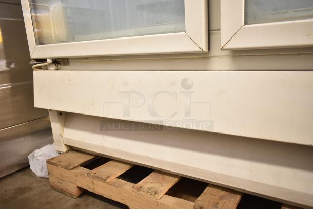 Carrier ULG50BCP-5 commercial 2-door reach-in freezer, corner view; some dirt visible on surface, placed on wooden pallet.