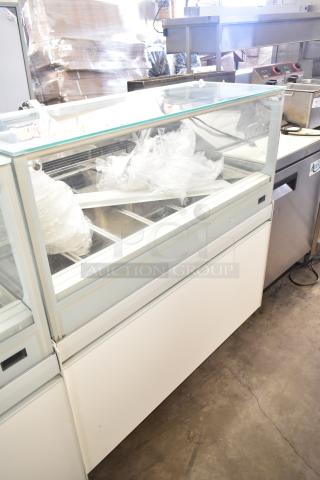Commercial floor-style gelato display case merchandiser, glass front, multiple compartment trays, good condition.