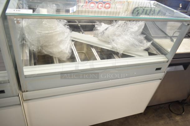 Commercial floor-style gelato display case merchandiser, glass top, multiple compartments, clean condition.