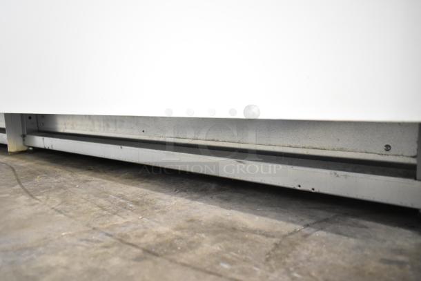 Commercial floor style gelato display case, featuring a sturdy metal base. Appears in used condition; no visible labels or tags.