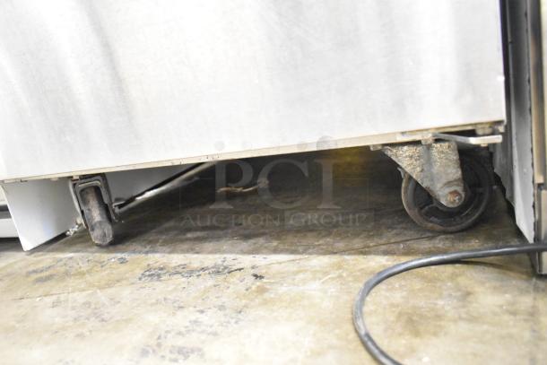 2024 Avantco 178APT27HC commercial sandwich salad prep table on casters. Visible wear on caster wheels.