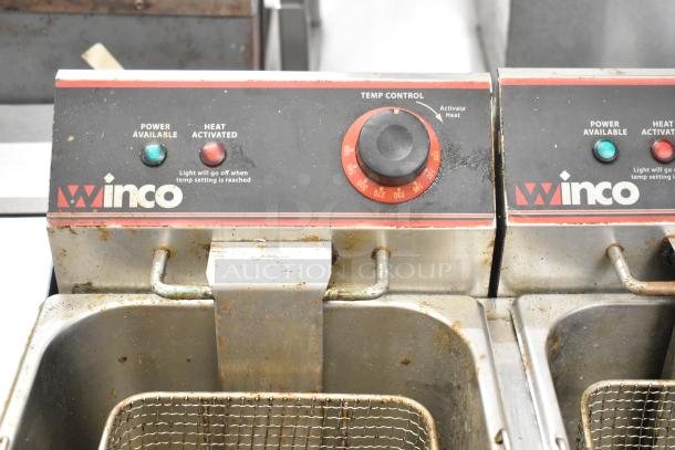Winco countertop electric 2 bay fryer with 2 metal fry baskets, used condition, temperature control and indicator lights visible.