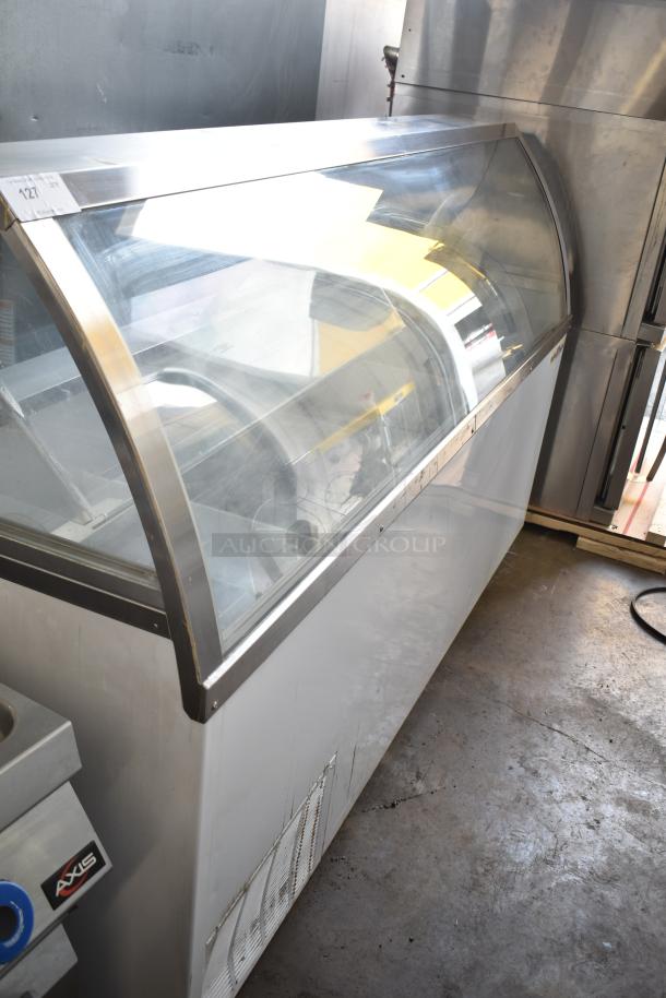 Commercial floor-style ice cream dipping cabinet with curved glass canopy, stainless steel frame, and ventilation panel.